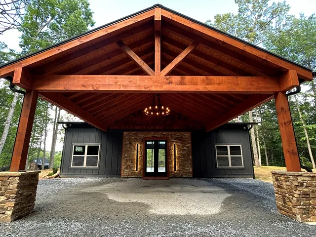 a view of an empty room with wooden floor and closet