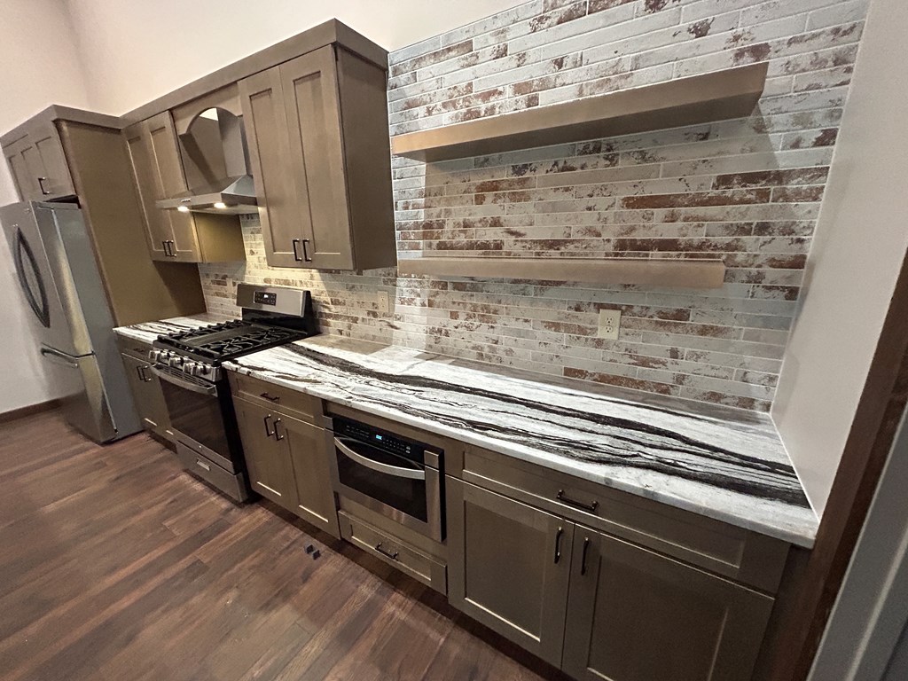 2461 Salem Road Mineral Bluff, GA 30559 - Photo 40 of 86 a kitchen with granite countertop a stove microwave and cabinets