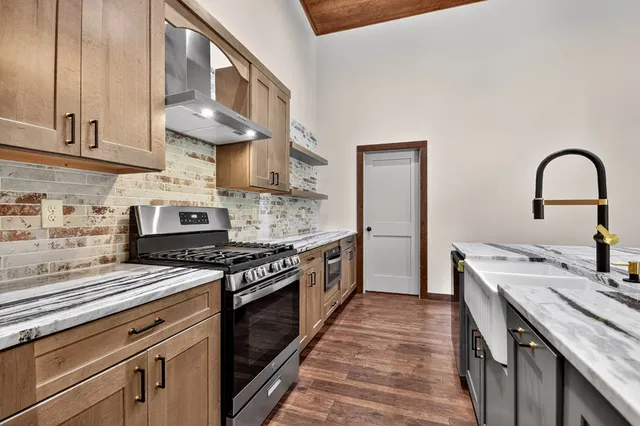 a living room with furniture a fireplace and a floor to ceiling window