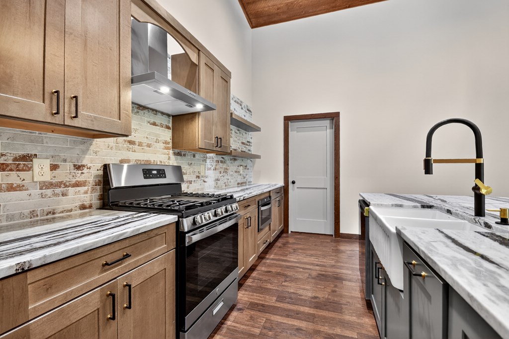 2461 Salem Road Mineral Bluff, GA 30559 - Photo 45 of 86 a kitchen with stainless steel appliances granite countertop a stove a sink and a refrigerator