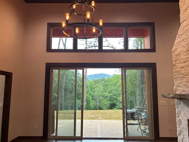 an empty room with wooden floor and window