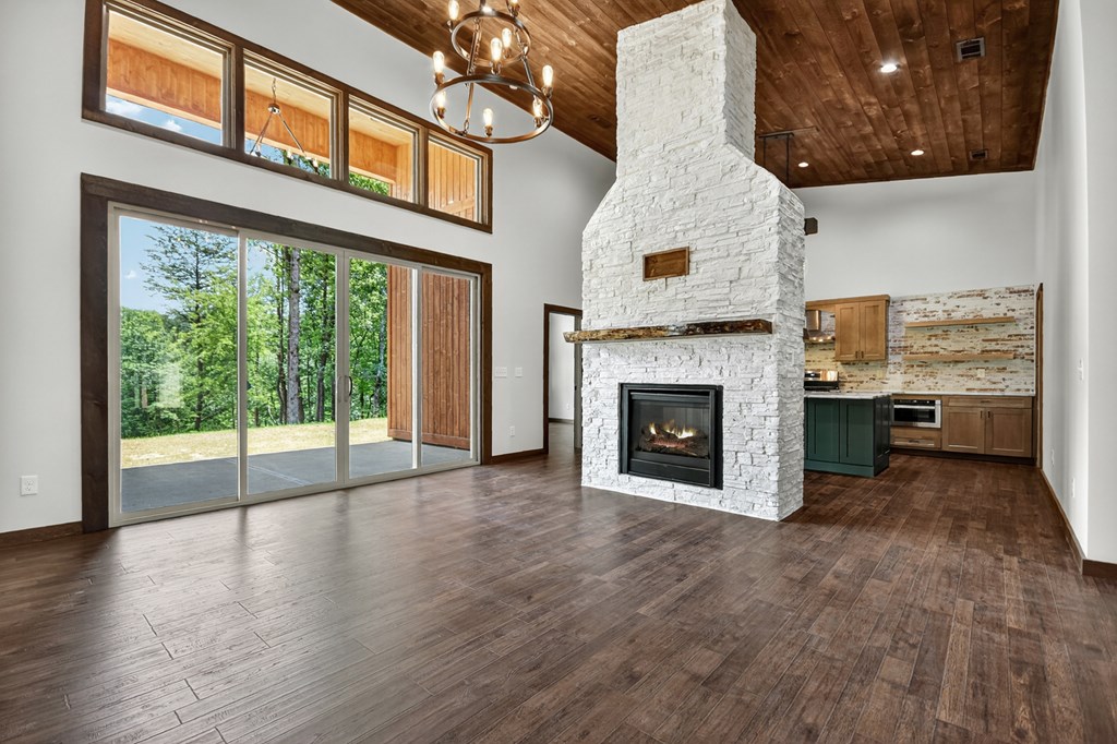 2461 Salem Road Mineral Bluff, GA 30559 - Photo 5 of 86 a view of an empty room with wooden floor and a fireplace