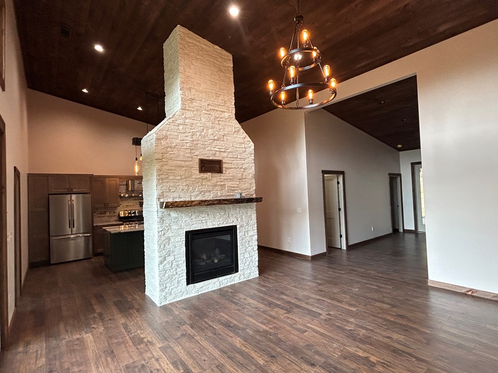 2461 Salem Road Mineral Bluff, GA 30559 - Photo 65 of 86 a view of a livingroom with a fireplace wooden floor and chandelier