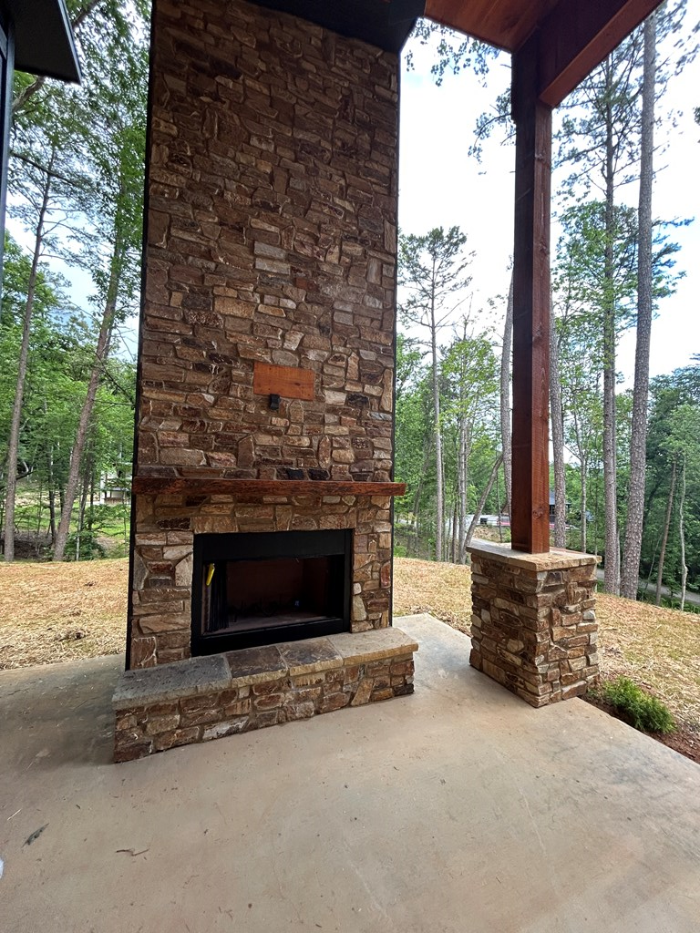 2461 Salem Road Mineral Bluff, GA 30559 - Photo 77 of 86 a living room with furniture a fireplace and a floor to ceiling window