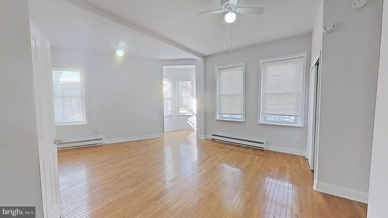 1234-40 Rising Sun Avenue, Unit C Philadelphia, PA 19140 - Photo 2 of 10 an empty room with wooden floor and windows