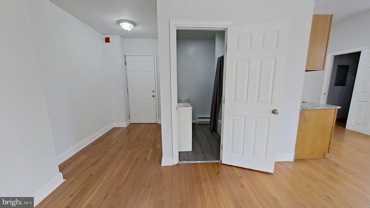 1234-40 Rising Sun Avenue, Unit C Philadelphia, PA 19140 - Photo 4 of 10 a view of wooden floor in an empty room with a mirror