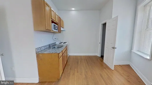 a storage room with wooden floor washer and dryer