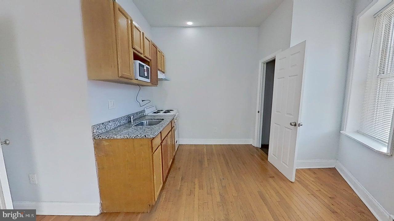 1234-40 Rising Sun Avenue, Unit C Philadelphia, PA 19140 - Photo 6 of 10 a storage room with wooden floor washer and dryer