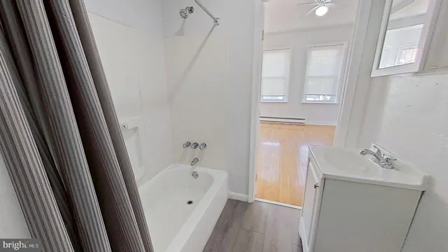 a bathroom with a tub sink and vanity