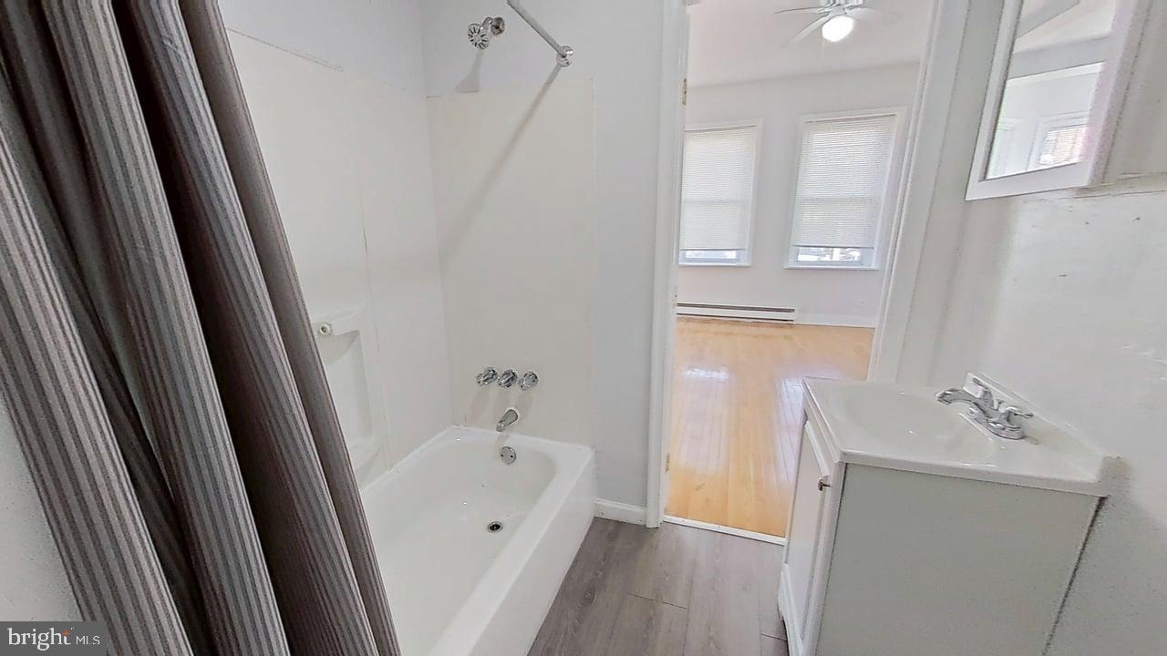 1234-40 Rising Sun Avenue, Unit C Philadelphia, PA 19140 - Photo 10 of 10 a bathroom with a tub sink and vanity