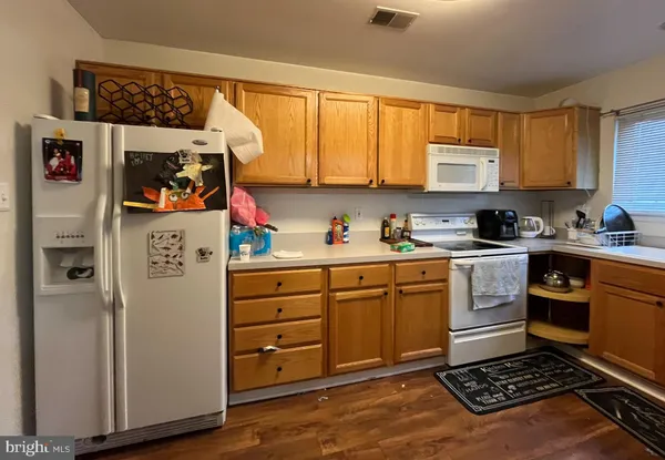 a kitchen with a refrigerator and cabinets