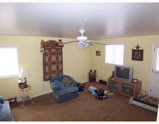 102 Baker Rd Extension Monaca, PA 15061 - Photo 12 of 12 a living room with furniture a chandelier and a window