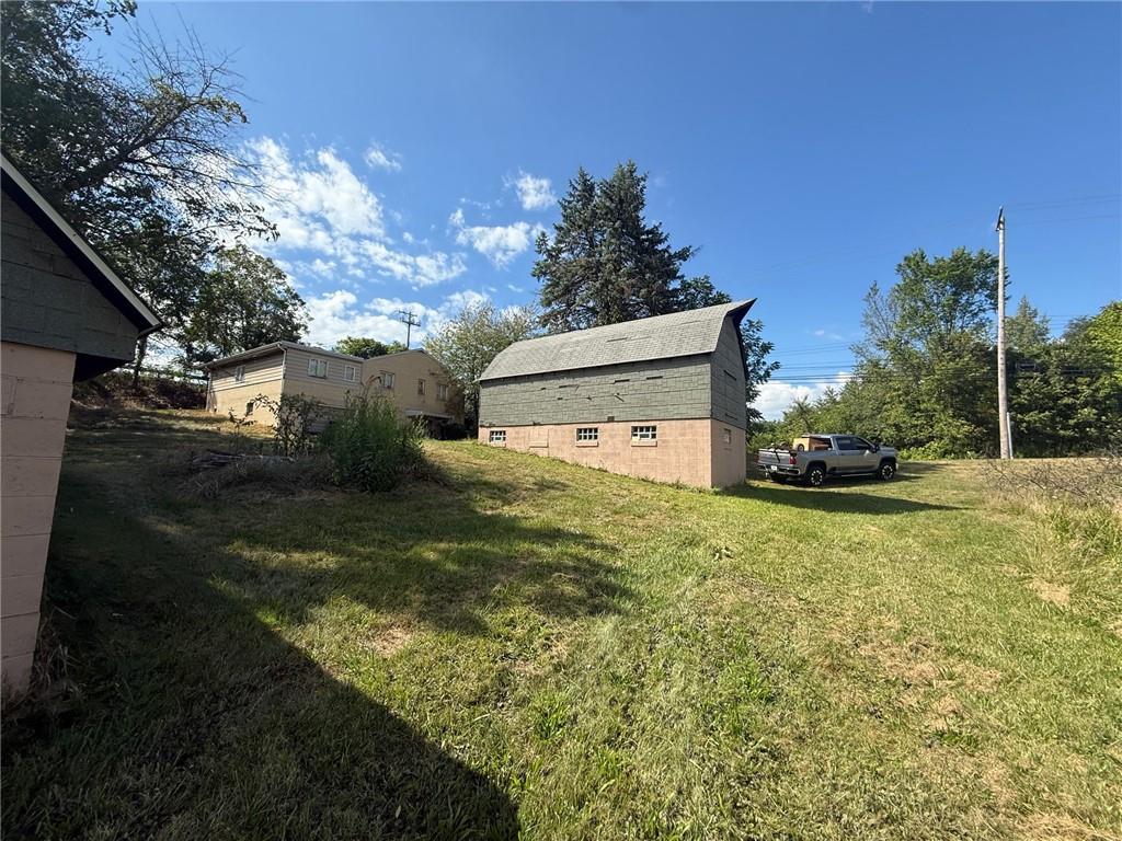 102 Baker Rd Extension Monaca, PA 15061 - Photo 3 of 12 a backyard of a house with lots of green space