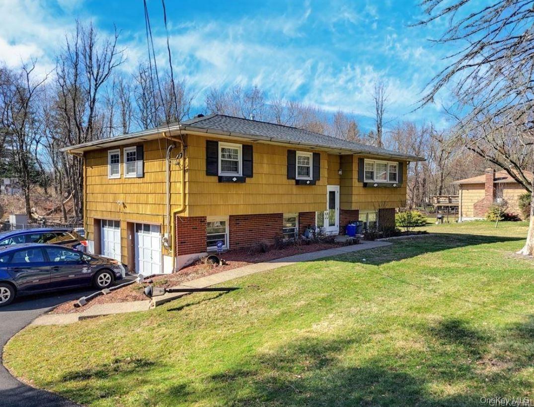 253 Hempstead Road Spring Valley, NY 10977 - Photo 1 of 1 Split-level residence featuring yellow siding and black louvered shutters