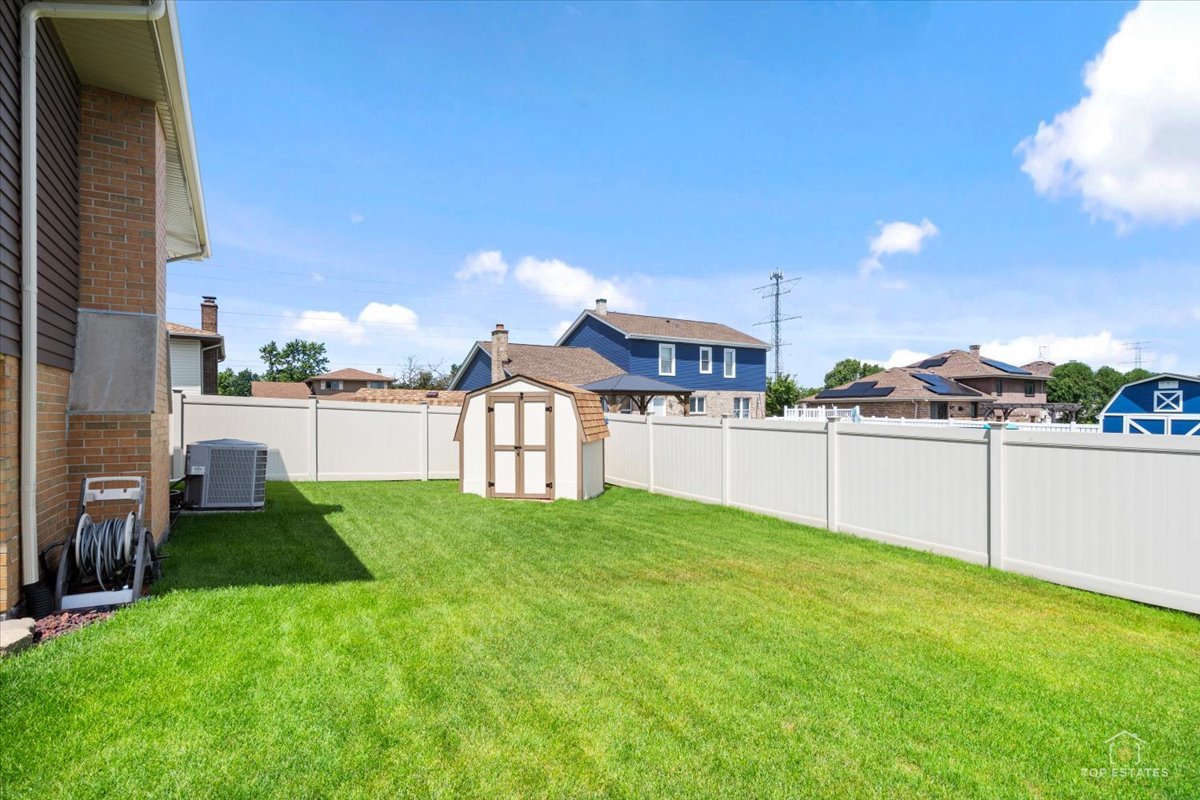 8124 Nottingham Road Tinley Park, IL 60477 - Photo 30 of 33 a view of a house with a yard and a fence