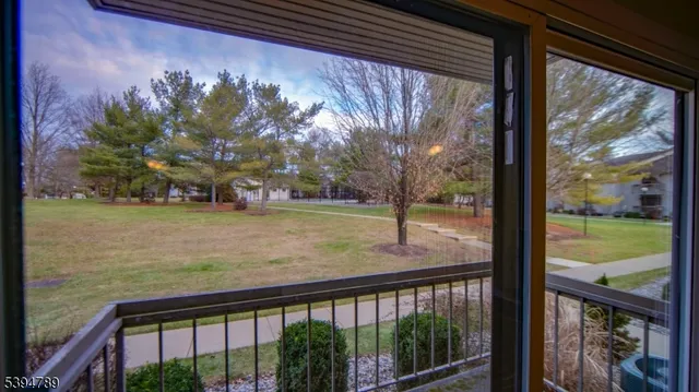 a view of a porch with a floor to ceiling window next to a yard