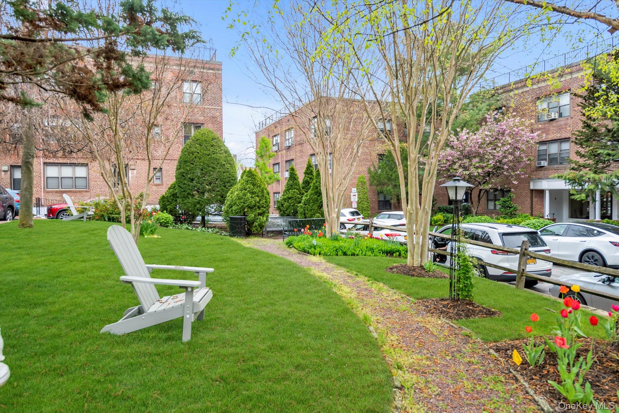 1 Town House Place, Unit 2E Great Neck, NY 11021 - Photo 17 of 17 a view of a chair and table in the garden
