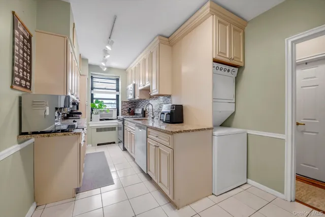 a kitchen with a sink cabinets and window