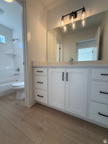 1142 West 220 North Mapleton, UT 84664 - Photo 17 of 26 Bathroom with light wood finished floors, vanity, and bathing tub / shower combination