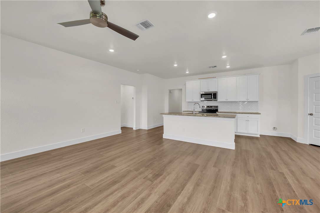 8905 Ponderosa Pine Road Temple, TX 76502 - Photo 3 of 16 a view of kitchen with wooden floor and window