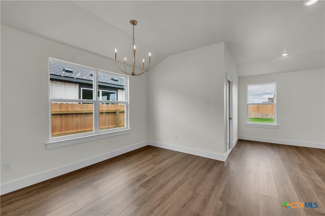 8905 Ponderosa Pine Road Temple, TX 76502 - Photo 7 of 16 a view of an empty room with a window and wooden floor