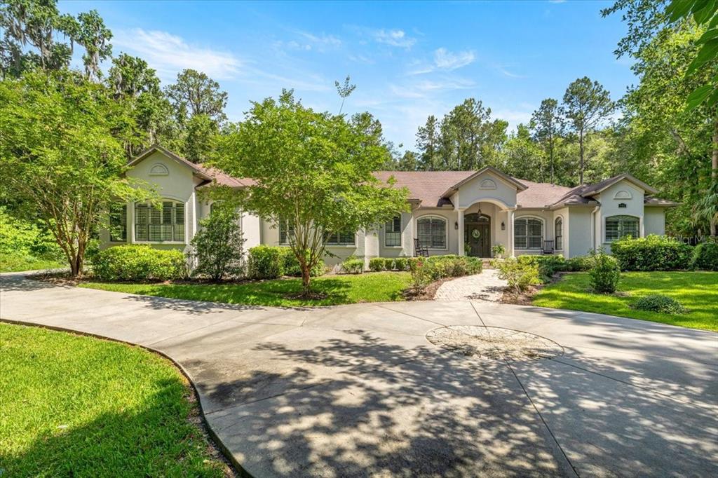 995 Southwest 37th Place Road Ocala, FL 34471 - Photo 1 of 1 a front view of a house with a yard and a garden