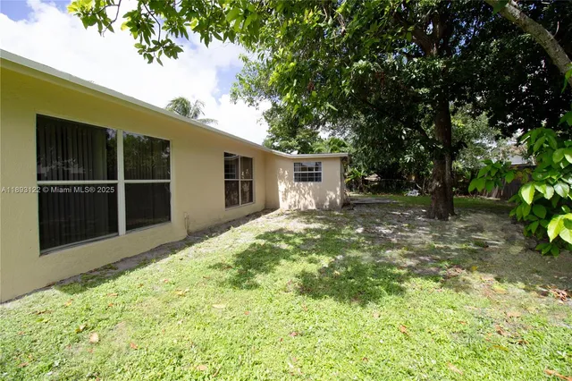 a view of a backyard with a tree