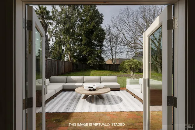 a view of a patio with couches and pool