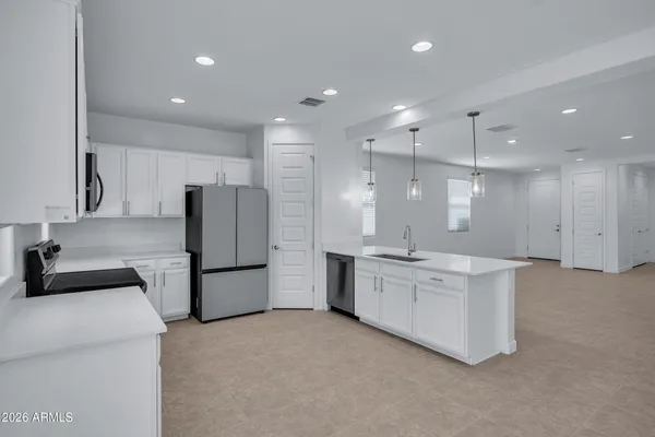 a kitchen with a sink appliances and cabinets