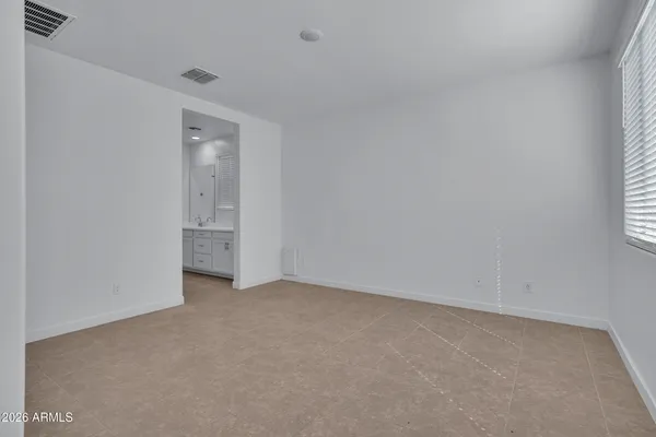 a view of an empty room and closet area