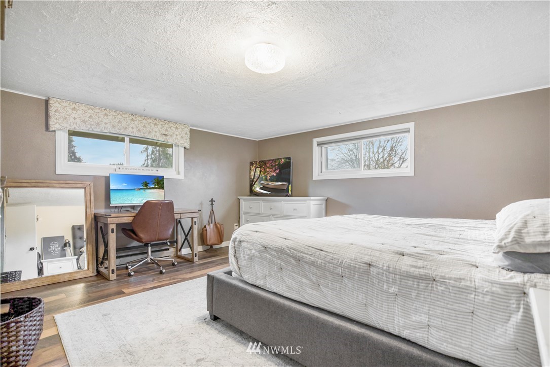8604 Riverside Drive East Sumner, WA 98390 - Photo 8 of 22 a bedroom with a bed and wooden floor