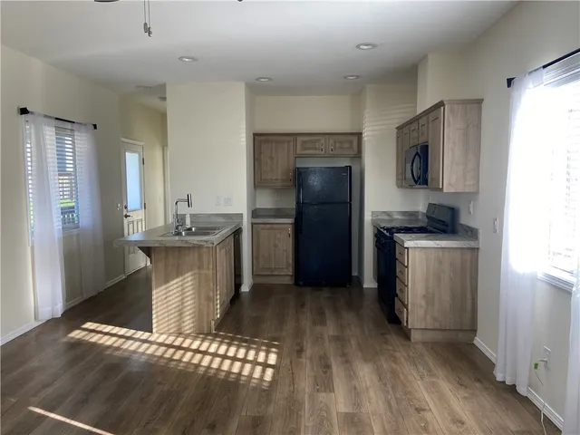 a kitchen with stainless steel appliances a refrigerator sink and stove