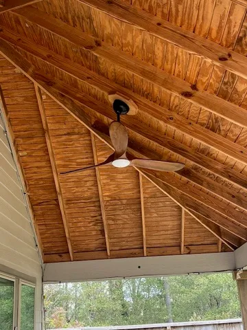a view of a backyard with wooden fence