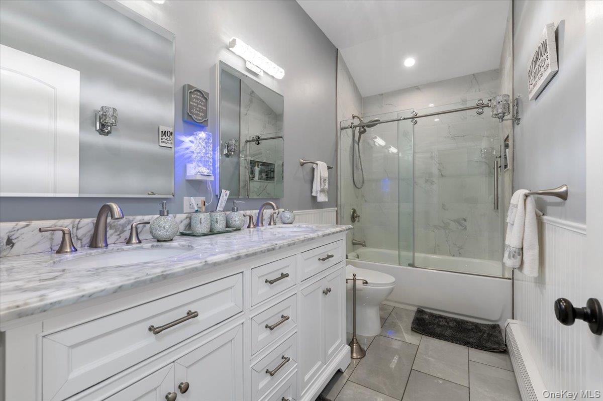 212 Locust Drive Rocky Point, NY 11778 - Photo 14 of 38 a bathroom with a granite countertop sink a toilet a mirror and shower