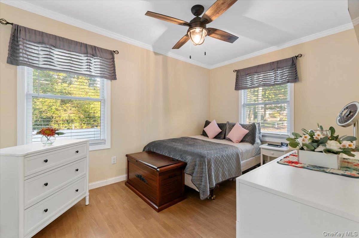 212 Locust Drive Rocky Point, NY 11778 - Photo 16 of 38 a bedroom with two beds and a chandelier