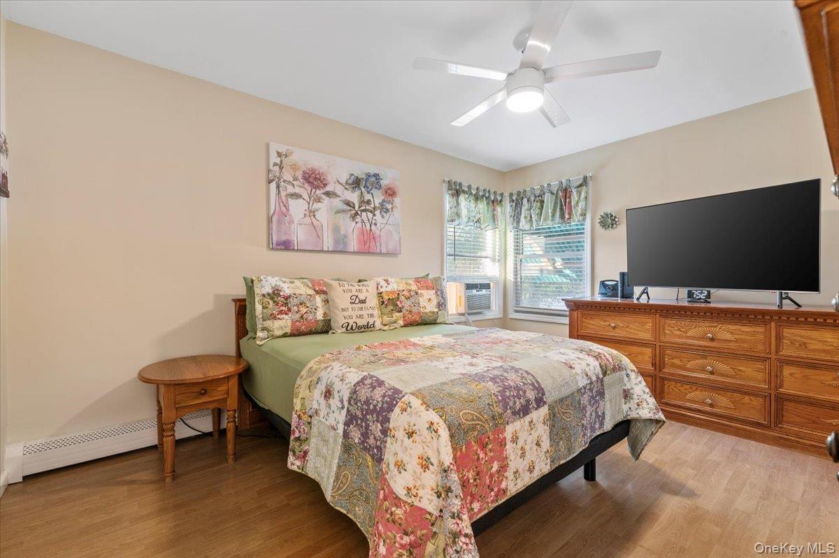 212 Locust Drive Rocky Point, NY 11778 - Photo 17 of 38 a bedroom with bed tv and window