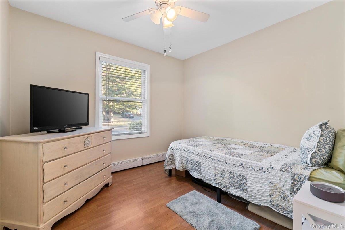 212 Locust Drive Rocky Point, NY 11778 - Photo 19 of 38 a bedroom with a bed and a flat screen tv
