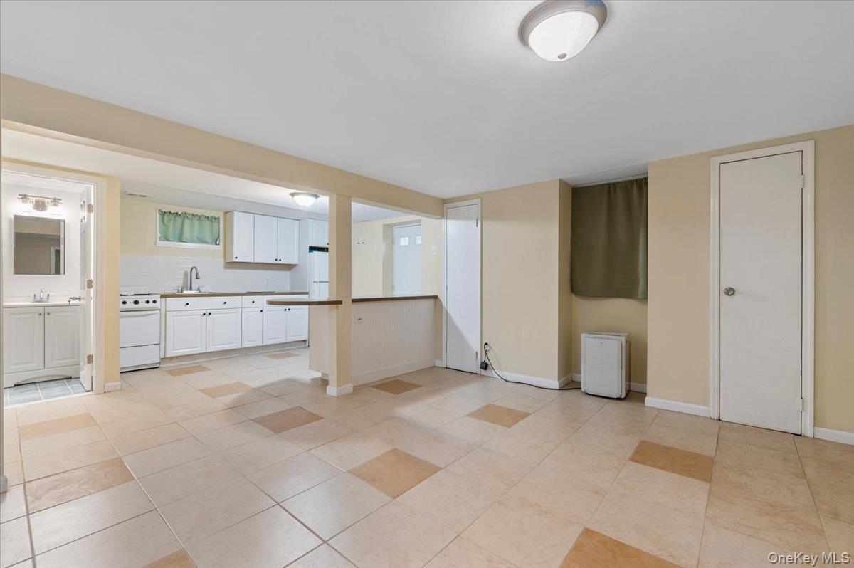 212 Locust Drive Rocky Point, NY 11778 - Photo 24 of 38 a large white kitchen with cabinets and a refrigerator