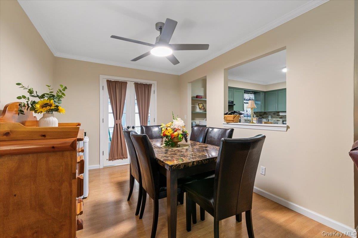 212 Locust Drive Rocky Point, NY 11778 - Photo 8 of 38 a view of a dining room with furniture and wooden floor
