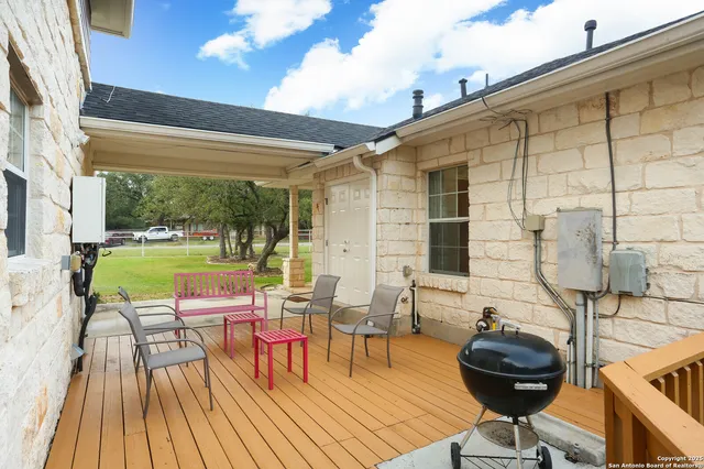 a balcony with table and chairs