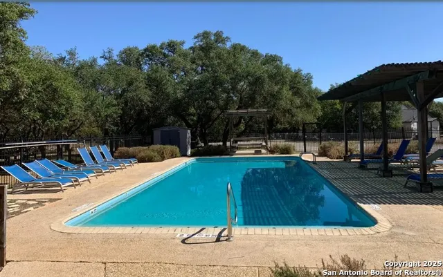 an aerial view of residential houses with outdoor space and swimming pool
