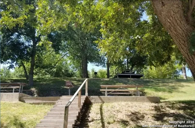 a view of a swimming pool with a yard and outdoor seating