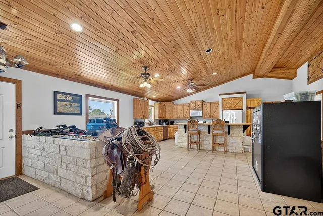 a open kitchen with white cabinets a dining table and chairs