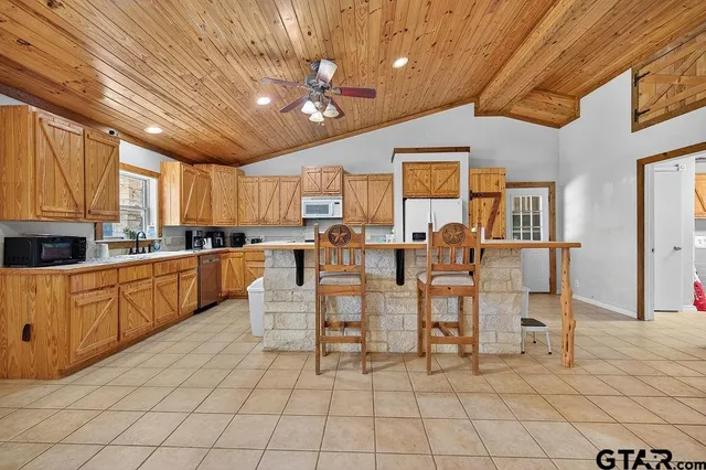 a kitchen with stainless steel appliances granite countertop a sink and cabinets