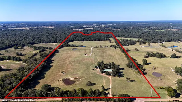 an aerial view of residential houses with outdoor space and swimming pool