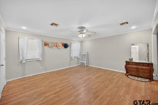 a view of a kitchen with furniture and wooden floor
