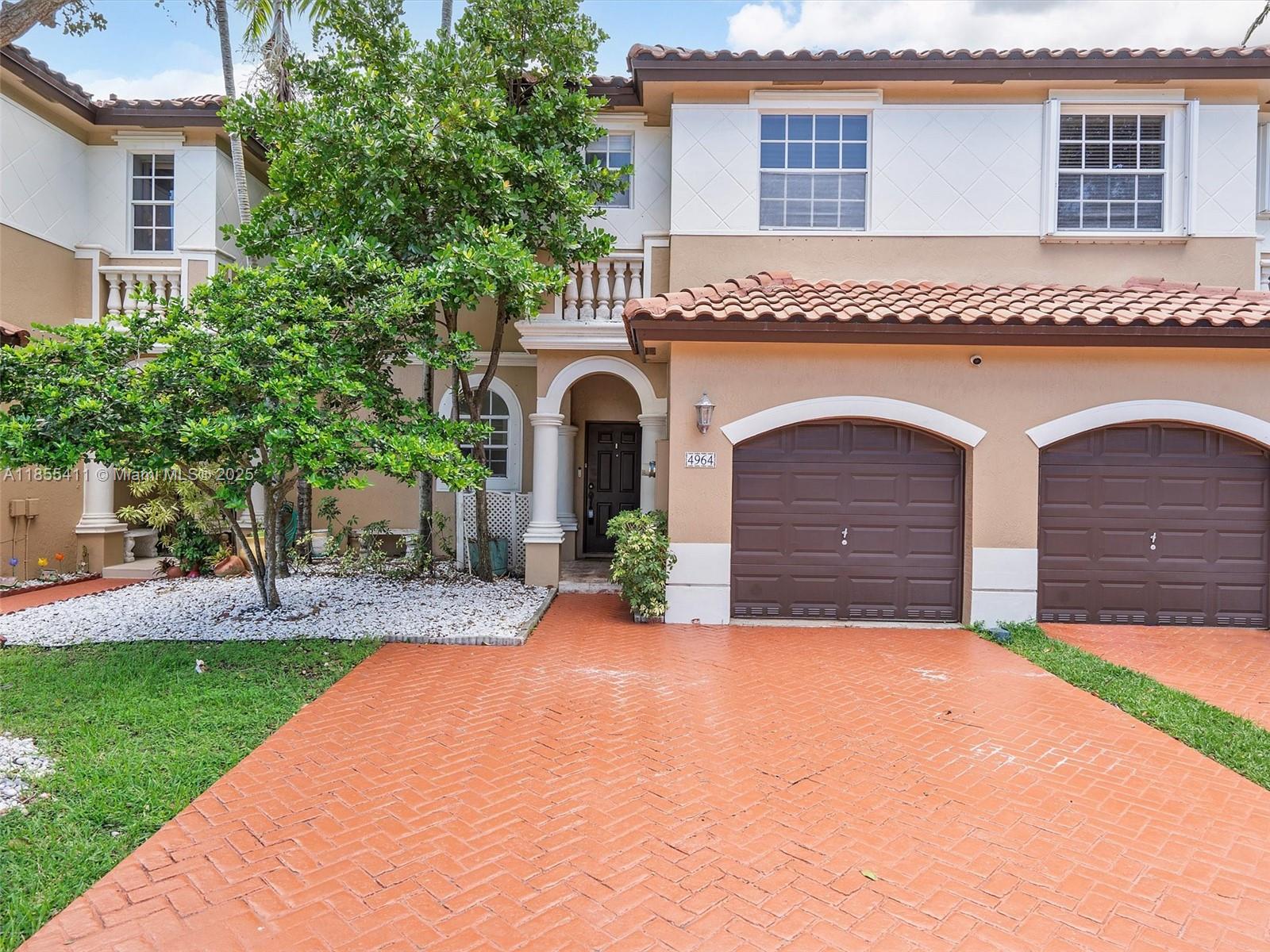 4964 Southwest 128th Avenue Miramar, FL 33027 - Photo 1 of 38 a front view of a house with garden