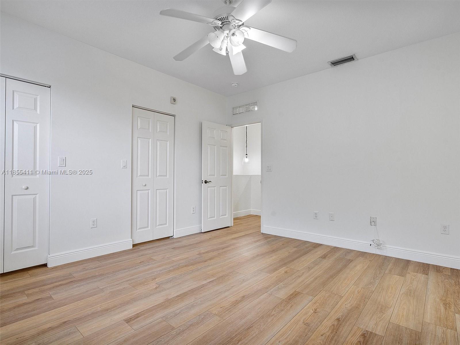 4964 Southwest 128th Avenue Miramar, FL 33027 - Photo 18 of 38 a view of an empty room with wooden floor