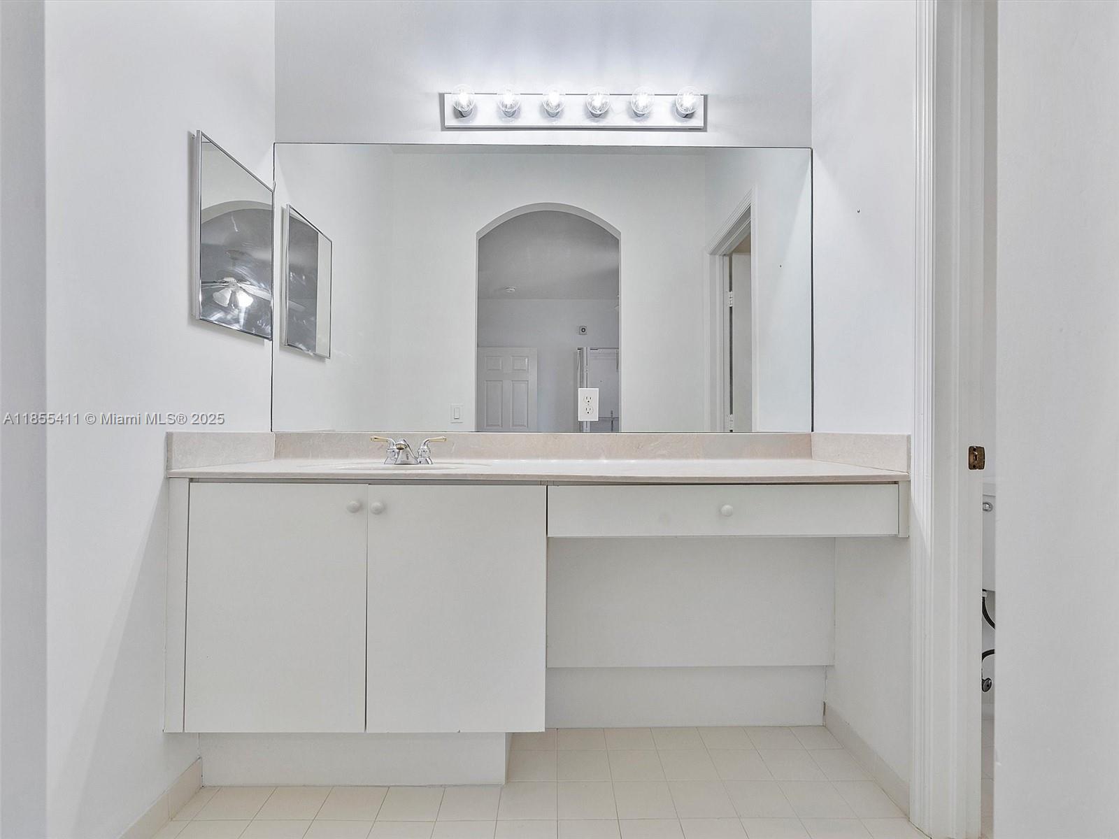 4964 Southwest 128th Avenue Miramar, FL 33027 - Photo 23 of 38 a bathroom with a sink and a mirror