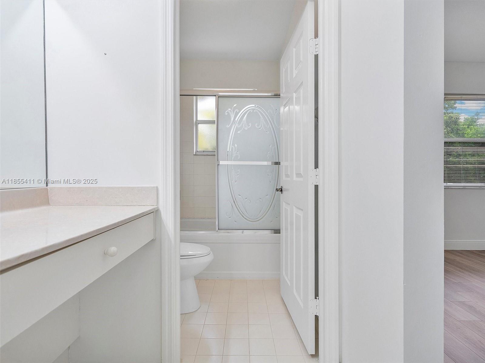 4964 Southwest 128th Avenue Miramar, FL 33027 - Photo 24 of 38 a bathroom with a sink a toilet and shower